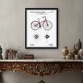 Framed bicycle patent diagram with red accents on a white background.